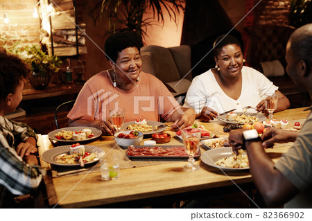 Family Enjoying Dinner at Table Family Enjoying Dinner at Table 82366902