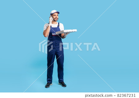 Portrait of worker man in uniform on blue background. 82367231