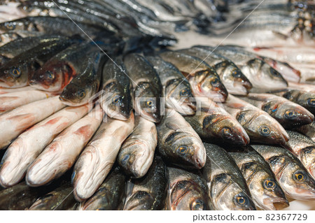 Fresh fish assorted on ice counter in supermarket Fresh fish assorted on ice counter in supermarket 82367729