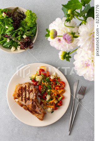 Pork entrecote on the bone with salad Pork entrecote on the bone with salad 82367776