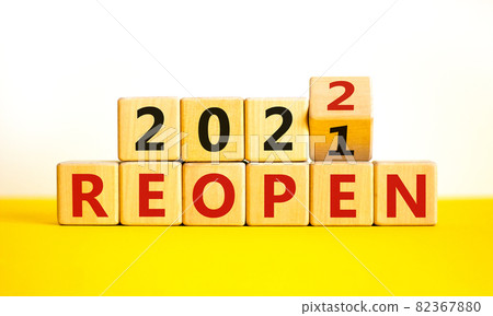 2022 reopen new year symbol. Turned a wooden cube and changed words 'Reopen 2021' to 'Reopen 2022'. Beautiful white background, copy space. Business, 2022 reopen new year concept. 82367880
