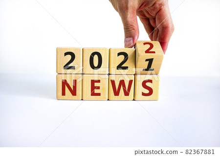2022 News new year symbol. Businessman turns a wooden cube and changes words 'News 2021' to 'News 2022'. Beautiful white background, copy space. Business, 2022 News new year concept. 82367881