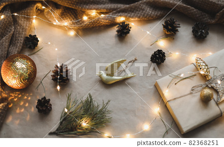 Christmas composition. Gift, fir tree branches, balls on craft paper background. Christmas, winter, new year concept. Flat lay, top view, copy space Christmas composition. Gift, fir tree branches, balls on craft paper background. Christmas, winter, new year concept. Flat lay, top view, copy space 82368251