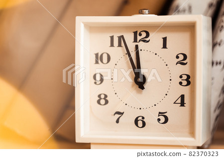 White vintage clock and pile of books White vintage clock and pile of books 82370323