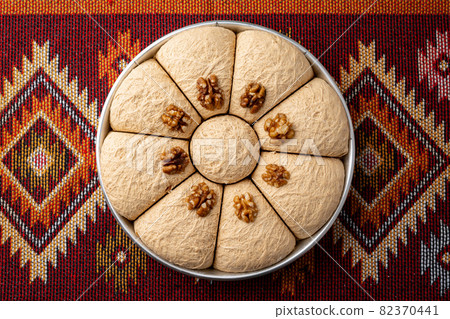 Top view of Turkish desserts on oriental patterned carpet 82370441