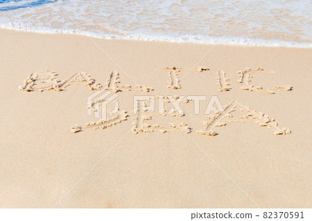 Inscription Baltic sea written on sandy beach. 82370591