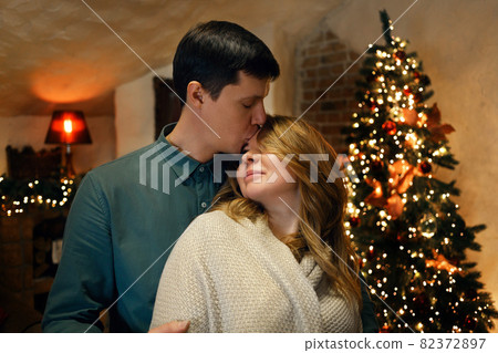 Beautiful caucasian middle aged couple kissing in new year interior 82372897