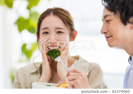 Young woman tired of eating broccoli Young woman tired of eating broccoli 82374060