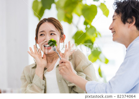 Young woman tired of eating broccoli Young woman tired of eating broccoli 82374064