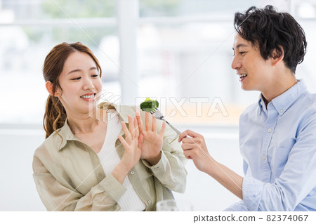 Young woman tired of eating broccoli Young woman tired of eating broccoli 82374067