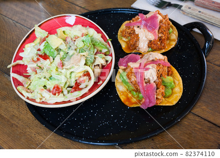Image of tasty chicken salad with avocado and tuna tostada 82374110