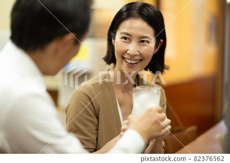 Middle-aged and older couples having fun drinking alcohol at a tavern Middle-aged and older couples having fun drinking alcohol at a tavern 82376562