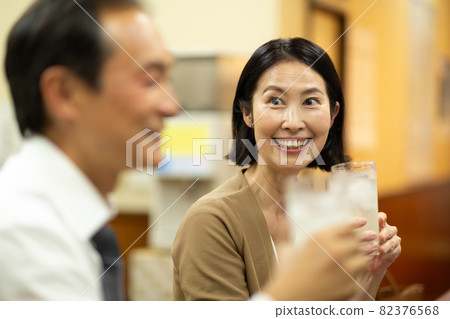Middle-aged and older couples having fun drinking alcohol at a tavern Middle-aged and older couples having fun drinking alcohol at a tavern 82376568