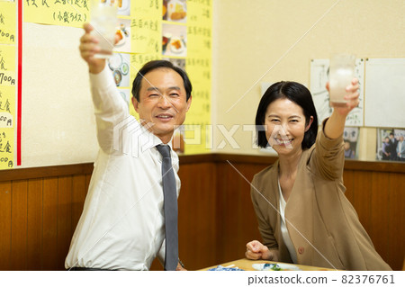 Middle men and women drinking alcohol at a tavern 82376761