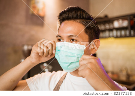 Waitress wearing a face mask at the coffee shop Waitress wearing a face mask at the coffee shop 82377138