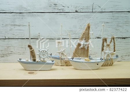 Nautical background with Sailboat Model on wooden background 82377422
