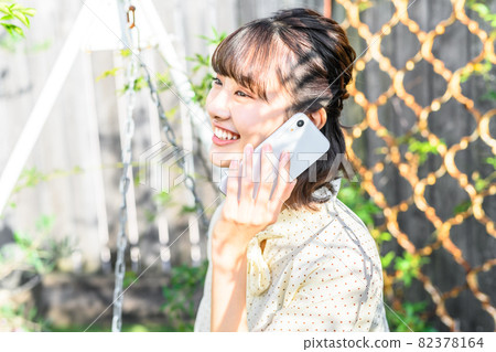A woman making a phone call A woman making a phone call 82378164