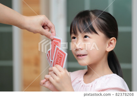 Girl playing cards to maid 82378208