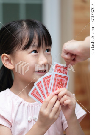 Girl playing cards to maid 82378209