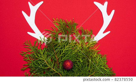 Festive Christmas deer made of green branches and ornaments Festive Christmas deer made of green branches and ornaments 82378550