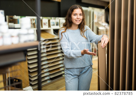Young woman buying flooring in hardware store Young woman buying flooring in hardware store 82378785