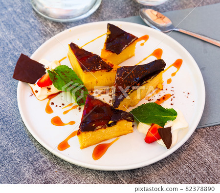 Custard tart on white plate, french cuisine 82378890