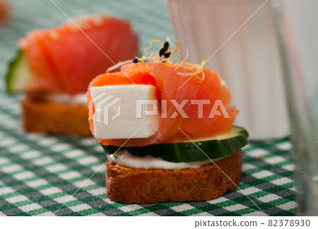 Canape with salmon, young cheese, cucumber Canape with salmon, young cheese, cucumber 82378930