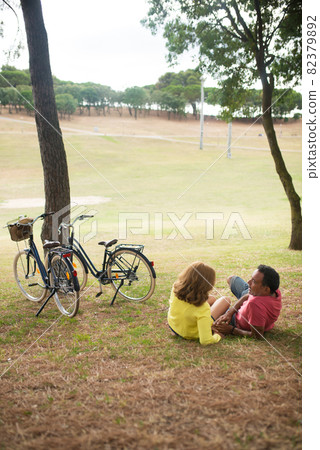 Happy mature couple resting in autumn park Happy mature couple resting in autumn park 82379892