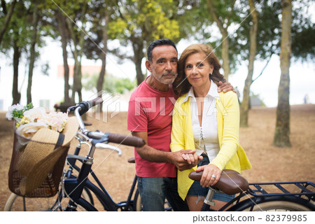 Portrait of happy mature couple cycling in park 82379985