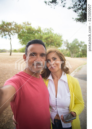 Portrait of happy mature couple taking selfie 82380007