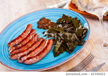 Fried frankfurters with green beans Fried frankfurters with green beans 82380922