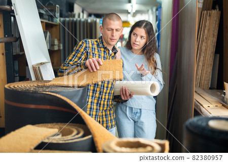 Married couple chooses a carpet in hardware store Married couple chooses a carpet in hardware store 82380957