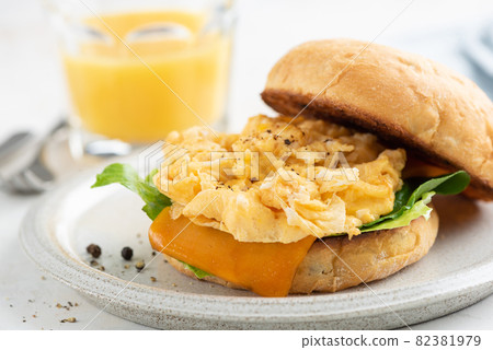 English muffin with scrambled eggs and cheese English muffin with scrambled eggs and cheese 82381979