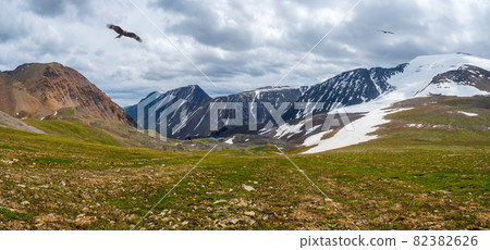 Panoramic autumn mountain valley, a dramatic rainy landscape with a stream and a rocky path in a gorge among green mountains. Altai Mountains. 82382626