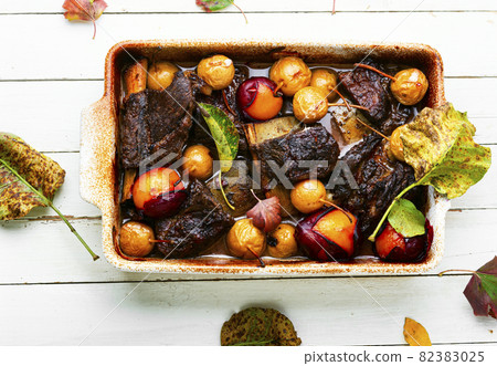 Beef ribs with plums and pears Beef ribs with plums and pears 82383025