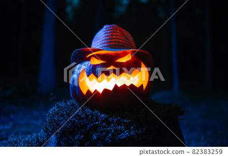 Lantern jack's head in hat on holiday against the background of the forest. Lantern jack's head in hat on holiday against the background of the forest. 82383259