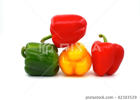 Red, green and yellow bell peppers on white Red, green and yellow bell peppers on white 82383529
