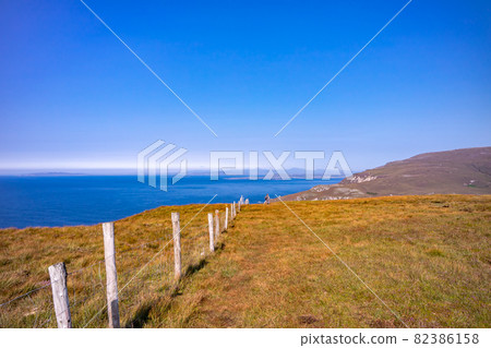 Fence at a coastal walk to Glenlough bay between Port and Ardara in County Donegal is Irelands most remote bay 82386158