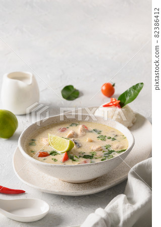 Spicy coconut Tom Kha Gai soup with chicken, cherry tomato. Asian Thai food. Spicy coconut Tom Kha Gai soup with chicken, cherry tomato. Asian Thai food. 82386412