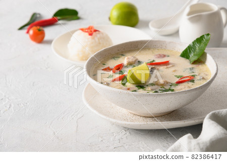 Spicy coconut Tom Kha Gai soup with chicken, cherry tomato. Asian Thai food. Spicy coconut Tom Kha Gai soup with chicken, cherry tomato. Asian Thai food. 82386417