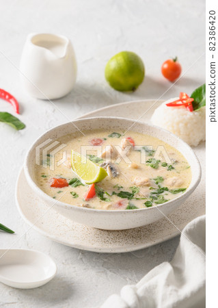 Spicy coconut Tom Kha Gai soup with chicken, cherry tomato. Asian Thai food. 82386420