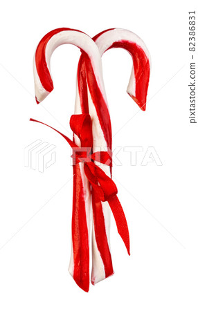Two candy canes isolated on white background Two candy canes isolated on white background 82386831
