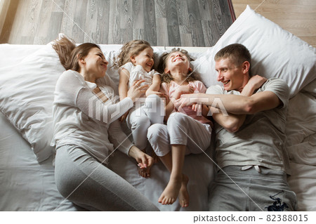 morning family: the children with parents playing in bed. waking up from a dream. I just woke up. love morning family: the children with parents playing in bed. waking up from a dream. I just woke up. love 82388015