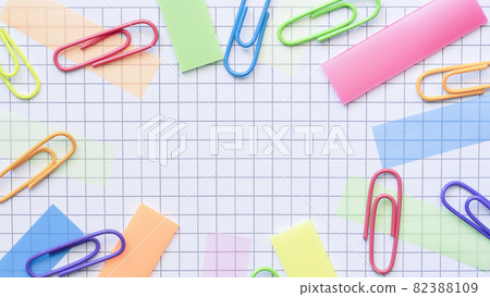 Multicolored stickers and paper clips on the blank checkered page. 82388109