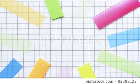 Multicolored stickers on the blank checkered page. Education concept. 82388122