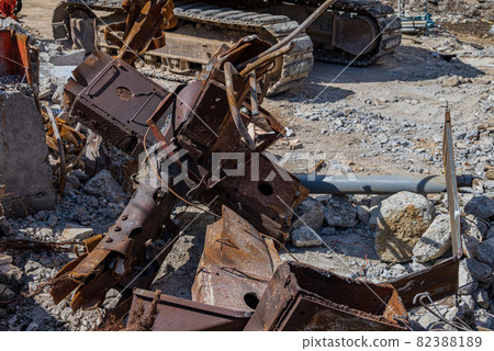 Heavy machinery and scrap iron at a demolition site Heavy machinery and scrap iron at a demolition site 82388189