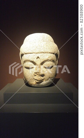 Head of a Buddha statue made of damaged stone 82388900