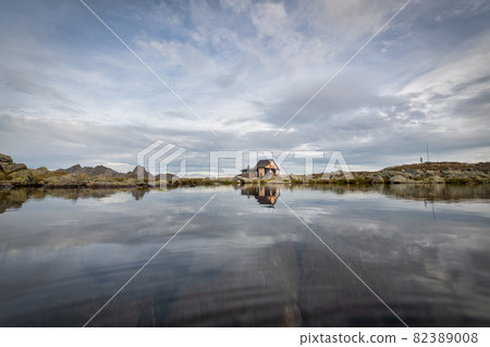 Small hermitage in the mountains near a lake Small hermitage in the mountains near a lake 82389008