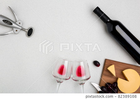 Wine, glasses and corkscrew over white background. Top view 82389108