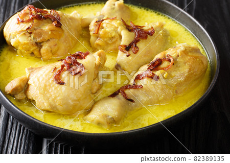 Opor ayam chicken cooked in coconut milk is one of many Indonesian dishes from Central Java close up in the bowl. Horizontal 82389135